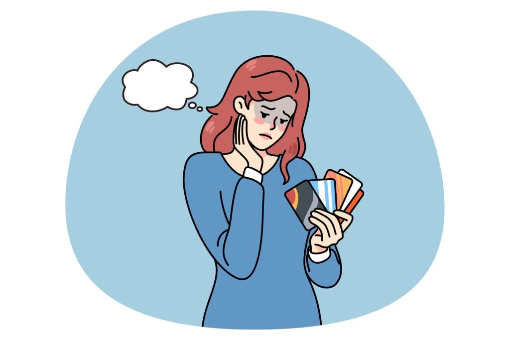 A woman holding a book with a thought bubble on it, thinking about how to pay off credit card debt fast.