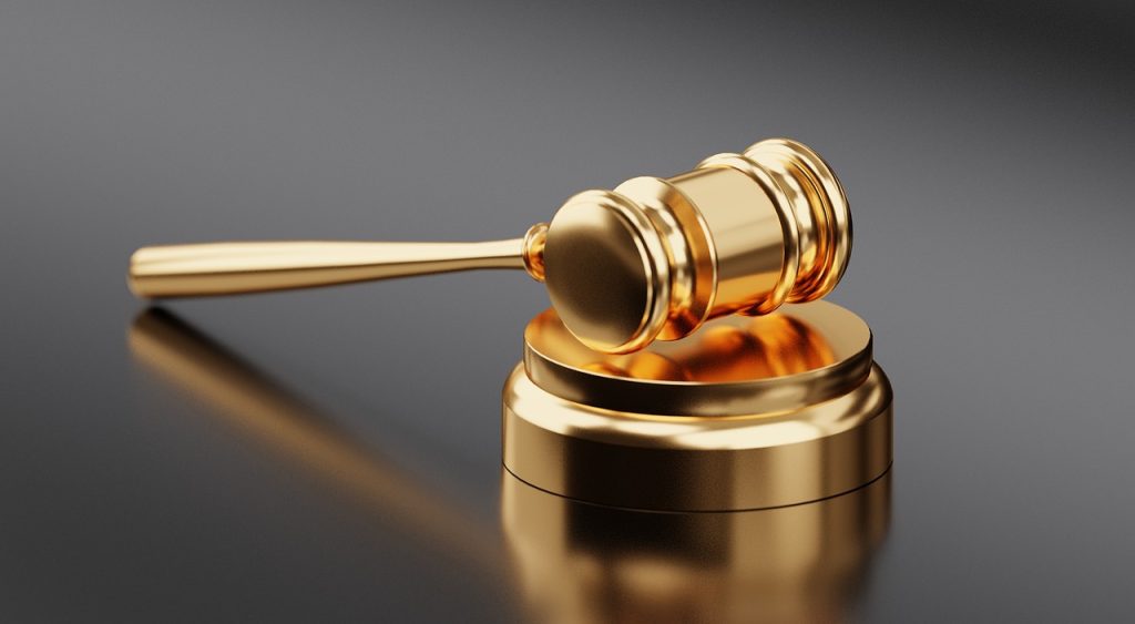 A golden gavel on a black background is a symbol of authority and justice. It represents the power to make legal decisions and resolve disputes. This image can evoke thoughts of how to get a debt lawsuit
